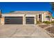 Two-story house with stone accents and a three-car garage at 4430 E Graythorn St, Phoenix, AZ 85044