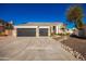 Two-story house with stone accents and a three-car garage at 4430 E Graythorn St, Phoenix, AZ 85044