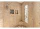 Spacious shower with glass block window and built-in shelving at 4430 E Graythorn St, Phoenix, AZ 85044