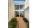 Modern glass entry doors leading to interior with a small courtyard at 4666 N 40Th St, Phoenix, AZ 85018