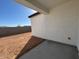 Covered patio and spacious backyard with dirt at 47489 W Kenner Dr, Maricopa, AZ 85139