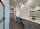 Modern bathroom with dual sinks, gray cabinets, and a large shower at 47489 W Kenner Dr, Maricopa, AZ 85139