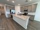 Modern kitchen with island and grey cabinets at 47489 W Kenner Dr, Maricopa, AZ 85139