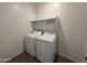 Laundry room with washer, dryer, and shelving at 47489 W Kenner Dr, Maricopa, AZ 85139