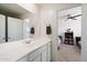 Bathroom with sink and vanity, plus view of bedroom at 47558 W Mellen Ln, Maricopa, AZ 85139