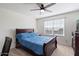 Bedroom with wooden bed frame and blue bedding at 47558 W Mellen Ln, Maricopa, AZ 85139