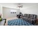 Bright bonus room with comfy couch and workspace at 47558 W Mellen Ln, Maricopa, AZ 85139