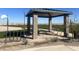 Outdoor community pavilion with seating, picnic tables, and basketball court nearby at 47558 W Mellen Ln, Maricopa, AZ 85139