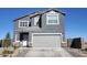 Two-story home with gray exterior, attached garage, and landscaping at 47558 W Mellen Ln, Maricopa, AZ 85139