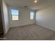 Bright bedroom with neutral carpeting and large windows at 47762 W Moeller Rd, Maricopa, AZ 85139