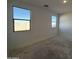 Spacious bedroom with two large windows at 47762 W Moeller Rd, Maricopa, AZ 85139