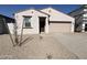 New single-story home with a two-car garage and desert landscaping at 47762 W Moeller Rd, Maricopa, AZ 85139