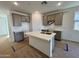 Modern kitchen with gray cabinets and island at 47762 W Moeller Rd, Maricopa, AZ 85139