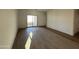 Living room with wood-look tile floor and sliding door at 47762 W Moeller Rd, Maricopa, AZ 85139