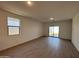 Spacious living area with tile flooring and sliding glass door at 47762 W Moeller Rd, Maricopa, AZ 85139