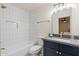 Modern bathroom with navy vanity, white tile, and gold fixtures at 501 W Yukon Dr # 8, Phoenix, AZ 85027