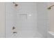 Clean bathroom with white tile, shower, and gold fixtures at 501 W Yukon Dr # 8, Phoenix, AZ 85027