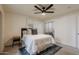 Cozy bedroom with a queen bed, ceiling fan, and access to bathroom at 501 W Yukon Dr # 8, Phoenix, AZ 85027