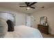 Bedroom with queen bed, ceiling fan, dresser, and access to bathroom at 501 W Yukon Dr # 8, Phoenix, AZ 85027