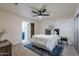 Bright bedroom with queen bed, ceiling fan and access to bathroom at 501 W Yukon Dr # 8, Phoenix, AZ 85027