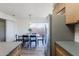 Bright dining area with wooden table and black chairs near the kitchen at 501 W Yukon Dr # 8, Phoenix, AZ 85027