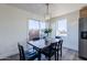 Dining area with a wooden table, gold light fixture, and view to backyard at 501 W Yukon Dr # 8, Phoenix, AZ 85027