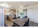 Dining area with wooden table and black chairs, view into kitchen at 501 W Yukon Dr # 8, Phoenix, AZ 85027