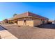 Tan stucco building with a tile roof and small landscaped area at 501 W Yukon Dr # 8, Phoenix, AZ 85027