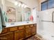 Bathroom with double vanity, shower, and wood cabinets at 5226 S 15Th St, Phoenix, AZ 85040