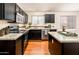 Modern kitchen featuring dark wood cabinets and granite countertops at 5226 S 15Th St, Phoenix, AZ 85040