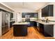 Modern kitchen with granite countertops, stainless steel appliances, and dark wood cabinets at 5226 S 15Th St, Phoenix, AZ 85040