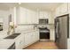 Well-equipped kitchen featuring white cabinets and granite countertops at 5350 E Deer Valley Dr # 4434, Phoenix, AZ 85054