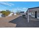 Backyard with gravel, covered patio, and storage shed at 5490 E Boise St, Mesa, AZ 85205