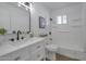 Updated bathroom with white vanity, bathtub and modern fixtures at 5490 E Boise St, Mesa, AZ 85205