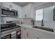 Modern kitchen with stainless steel appliances and white cabinetry at 5490 E Boise St, Mesa, AZ 85205