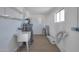 Laundry room with utility sink, water heater and shelving at 5490 E Boise St, Mesa, AZ 85205