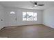 Bright living room featuring hardwood floors and large window at 5490 E Boise St, Mesa, AZ 85205