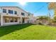 House's back elevation and backyard with a large grass area at 5720 W Robb Ln, Glendale, AZ 85310