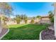 Large backyard with lush grass and a partially visible pool at 5720 W Robb Ln, Glendale, AZ 85310