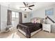 Bright bedroom with a queen-size bed and a ceiling fan at 5720 W Robb Ln, Glendale, AZ 85310