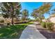 A paved pathway winds through a lush community landscape at 5720 W Robb Ln, Glendale, AZ 85310