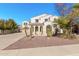 Two-story house with desert landscaping and a three-car garage at 5720 W Robb Ln, Glendale, AZ 85310