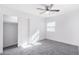 Bedroom with ceiling fan, grey carpet and sliding door at 603 S 7Th St, Avondale, AZ 85323