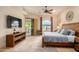 Main bedroom with king bed, TV, and sliding door to patio at 6168 S Fairway Pl, Gold Canyon, AZ 85118