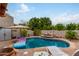 Spacious pool area with lounge chairs, umbrella, and waterfall feature at 6168 S Fairway Pl, Gold Canyon, AZ 85118