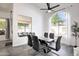 Bright dining area with glass table and black chairs, adjacent to patio at 6458 E Raftriver St, Mesa, AZ 85215