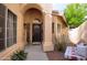 Front entry with dark door, arched entryway, and stone pathway at 6458 E Raftriver St, Mesa, AZ 85215