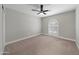 Spacious bedroom featuring a ceiling fan and arched window with shutters at 6630 E Dreyfus Ave, Scottsdale, AZ 85254