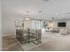 Open concept dining area with glass table, modern chairs, and stylish light fixture at 6630 E Dreyfus Ave, Scottsdale, AZ 85254