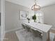 Elegant dining room features a white table, modern chairs, and a stylish light fixture at 6630 E Dreyfus Ave, Scottsdale, AZ 85254